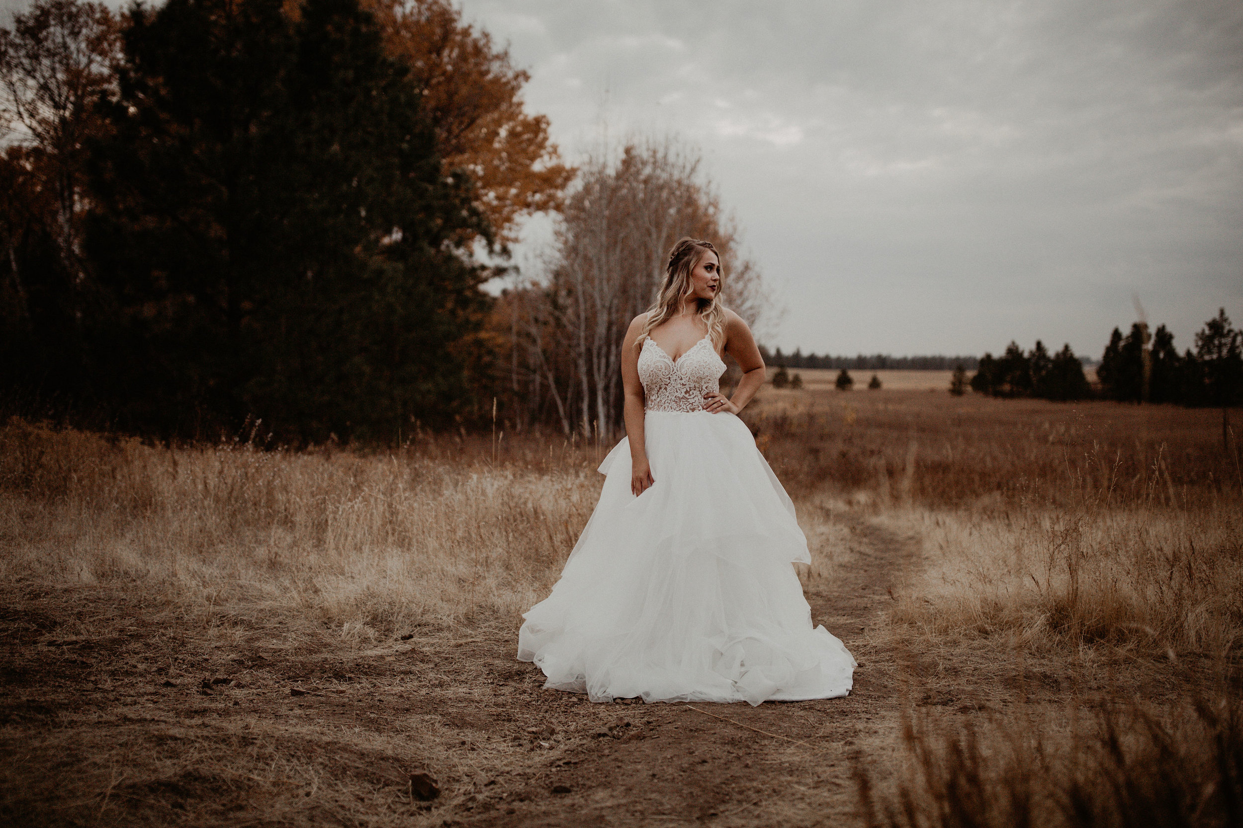 wedding dress in a field blonde bride