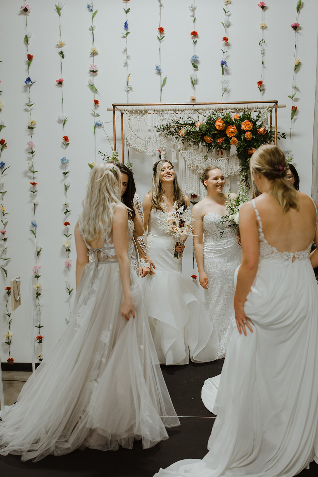 spokane wedding dress end of fashion show brides on runway laughing