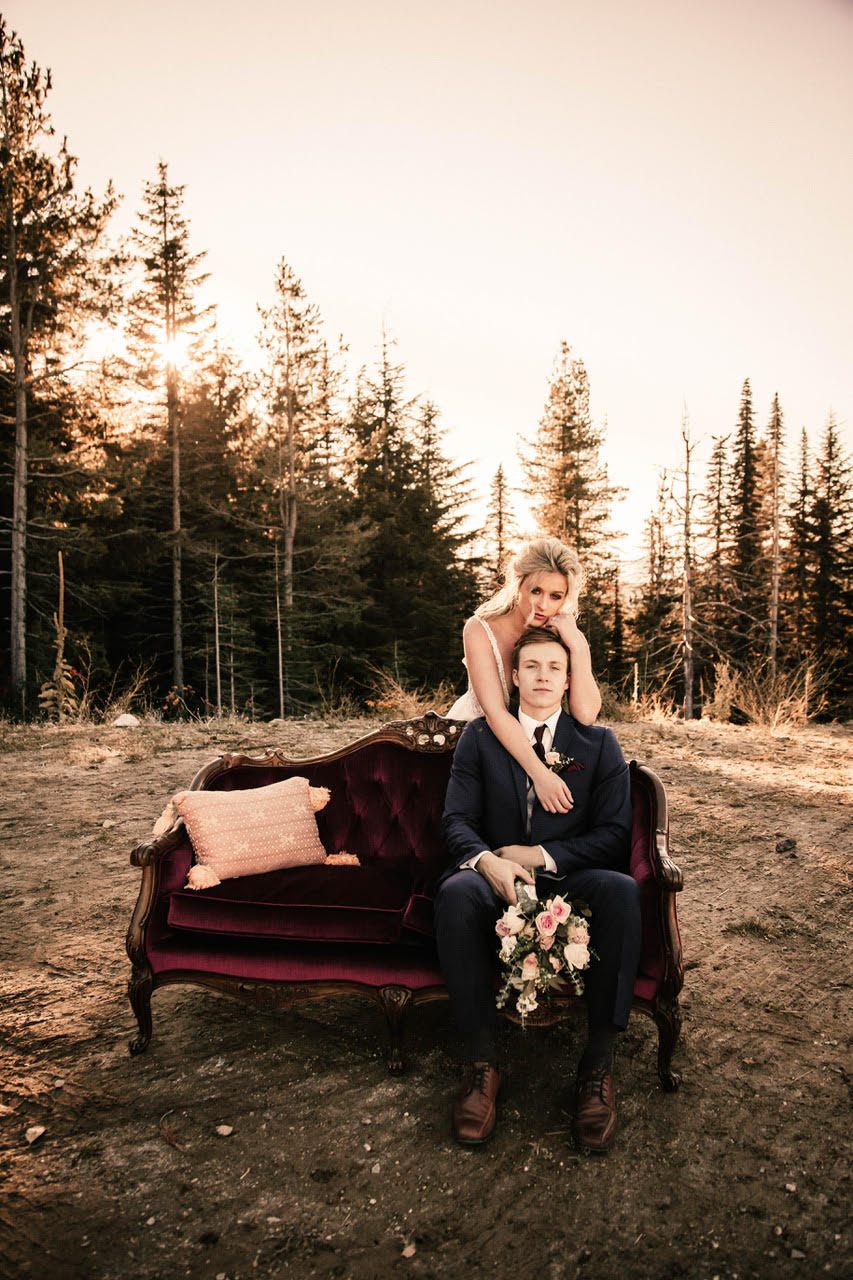 girl hugging groom on couch wedding dress image spokane