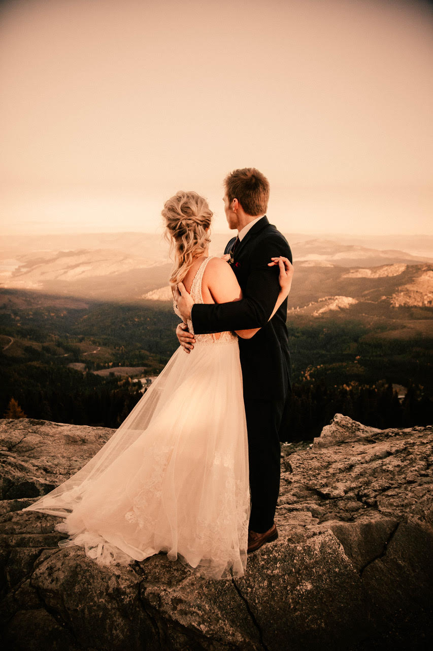 bride and groom looking out over my spokane in wedding dress