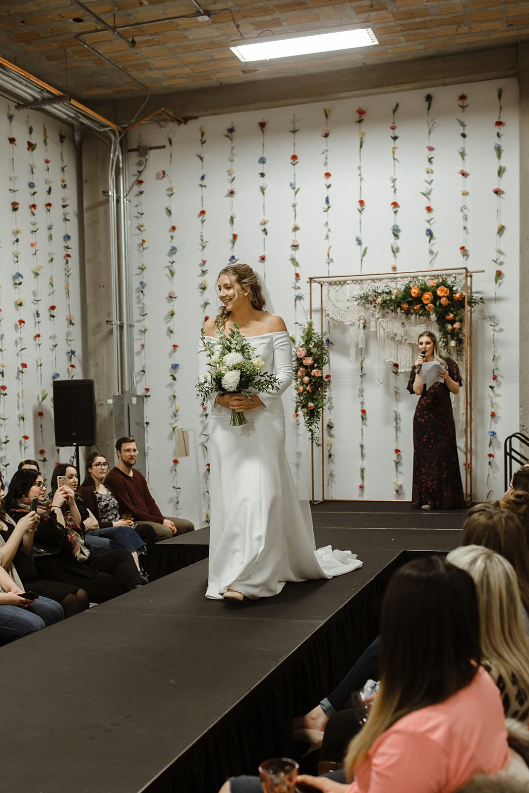 spokane wedding dress fashion show off shoulders runway model white flowers