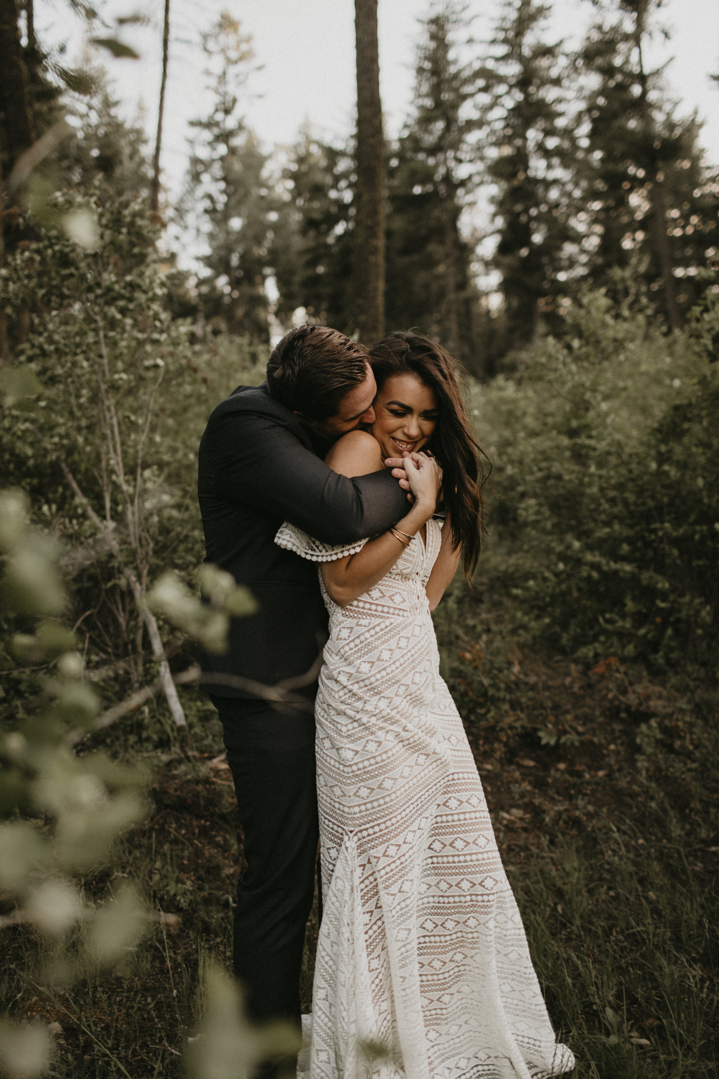 Spokane boho cattle wedding groom hugging bride surprise happy