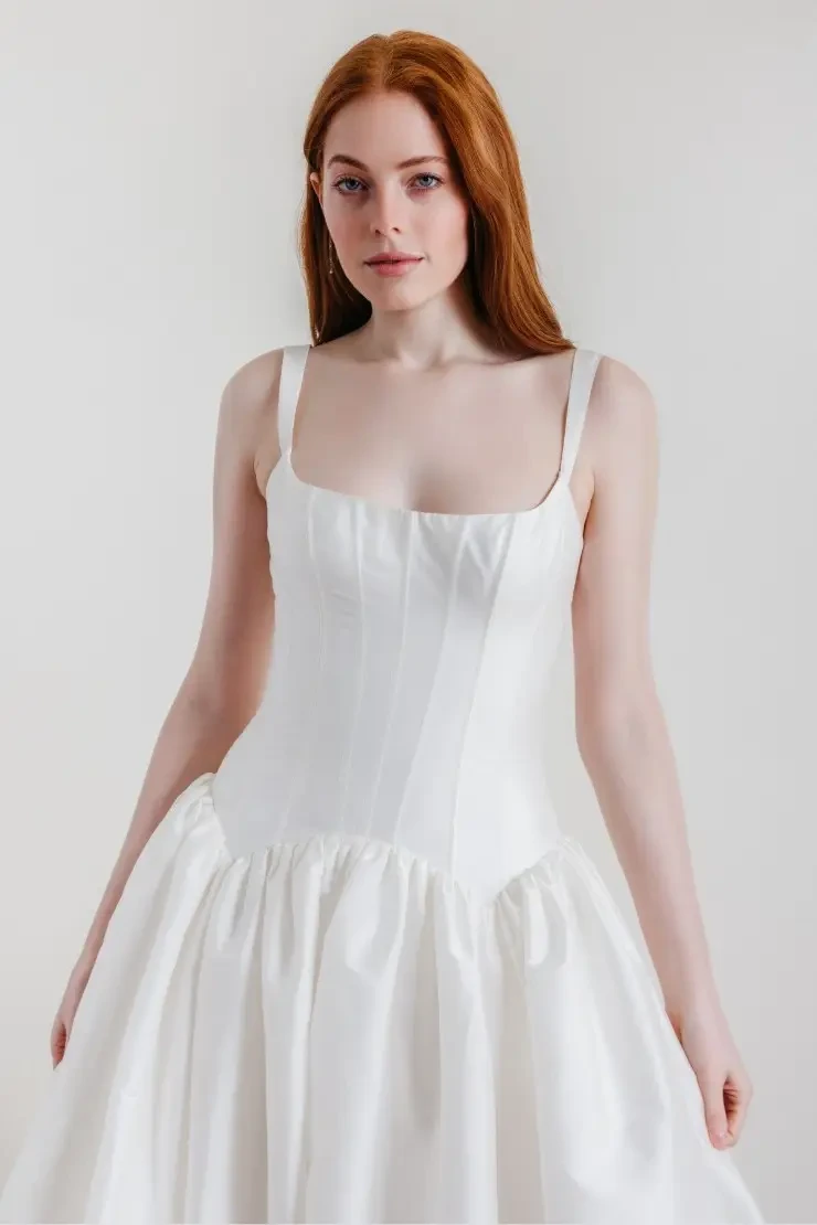 model is wearing a sleeveless square neckline wedding dress