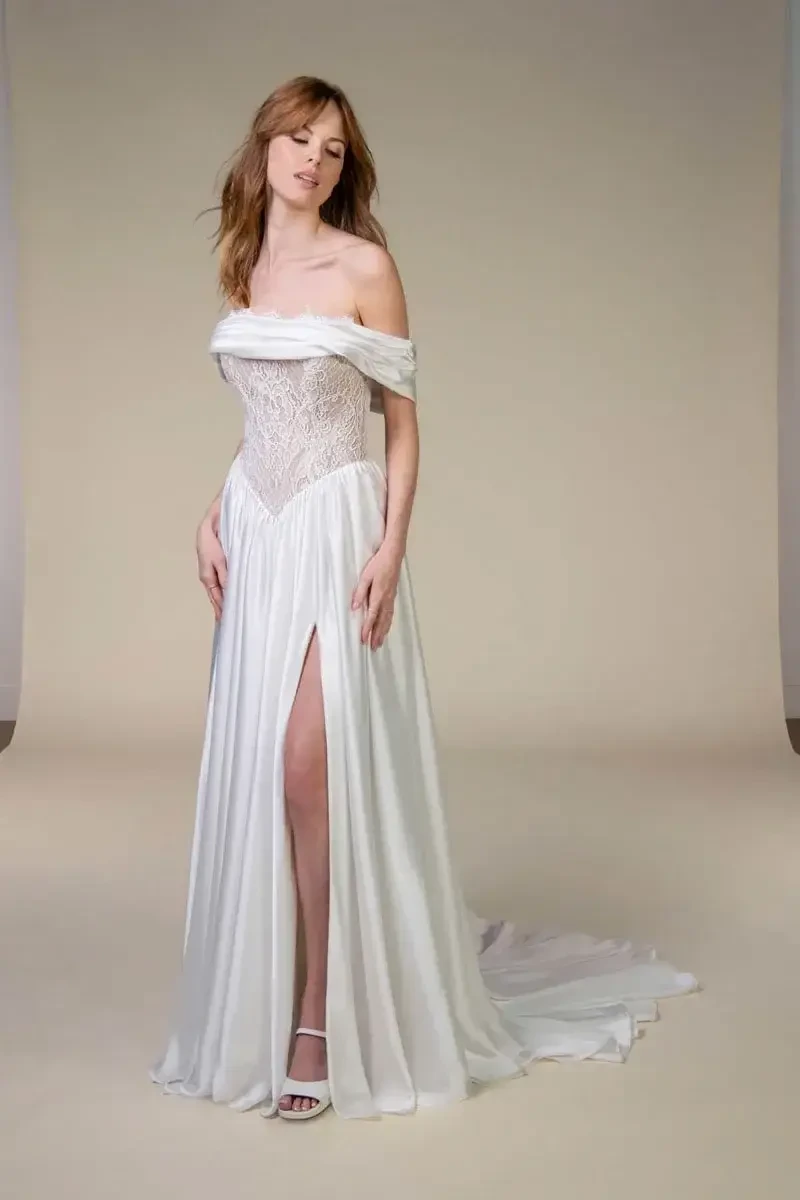 model is wearing an off the shoulder bridal gown