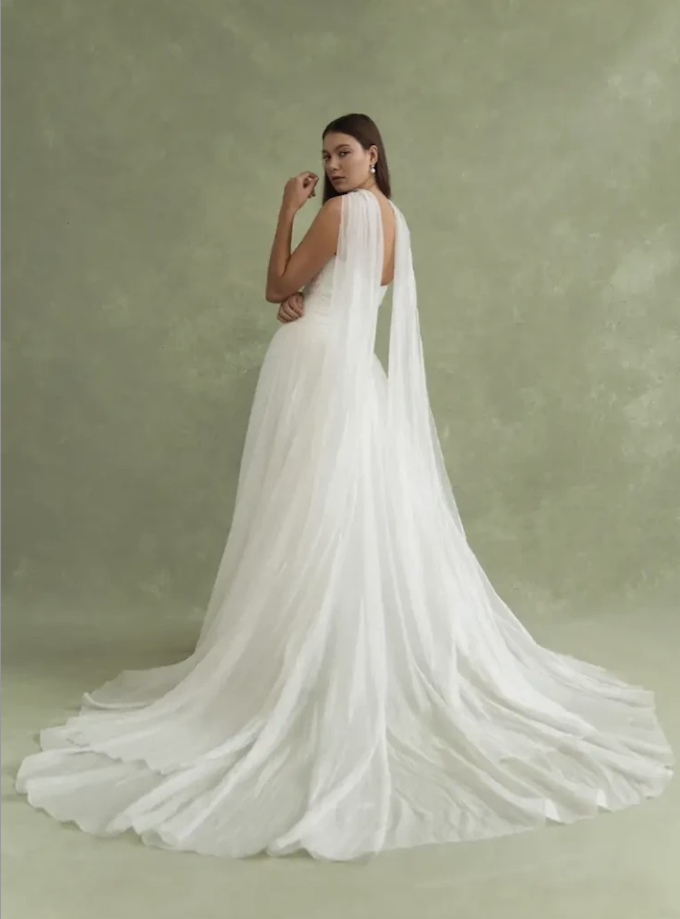 Model is wearing the Jenny by Jenny Yoo Lee gown, featuring an off-the-shoulder neckline, ruched bodice, dropped waist, and a clean A-line silhouette.